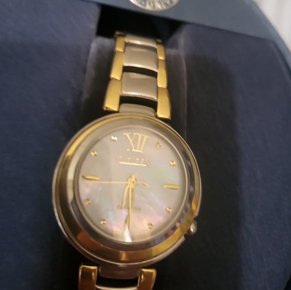 Citizens women's Eco-Drive watch with a pearl face and gold trim and a gold hand - Picture 6 of 13